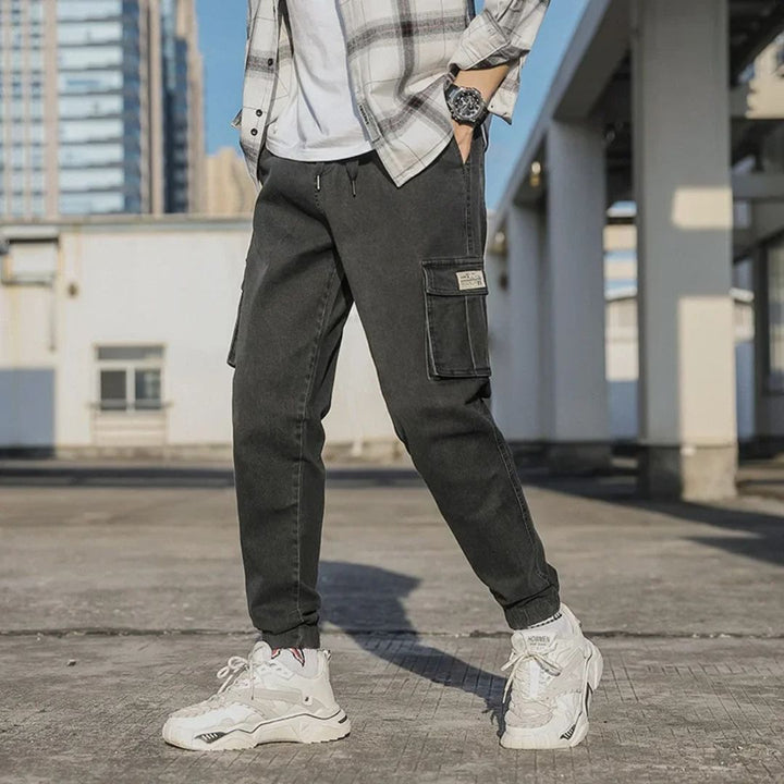 Men's Utility Denim Joggers with Pockets, soft denim, elastic waistband, multiple pockets, versatile casual streetwear pants.