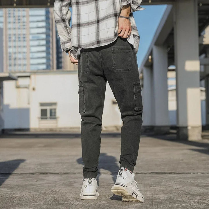 Men's Utility Denim Joggers with Pockets, soft denim, elastic waistband, multiple pockets, versatile casual streetwear pants.