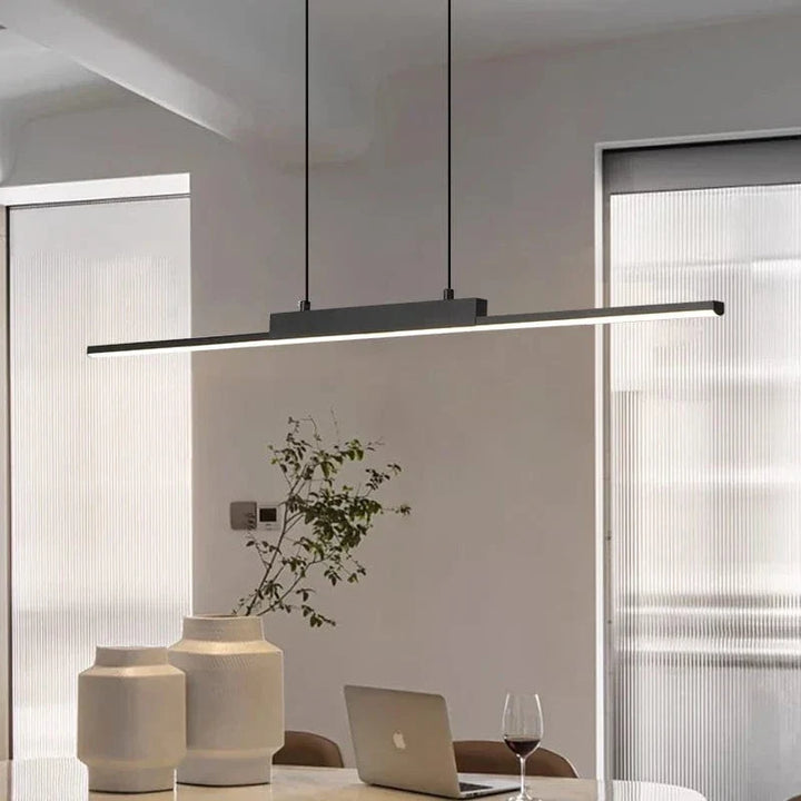 "Modern black pendant light with tubular silhouette, minimalist aluminium fixture, perfect for dining rooms and kitchens."