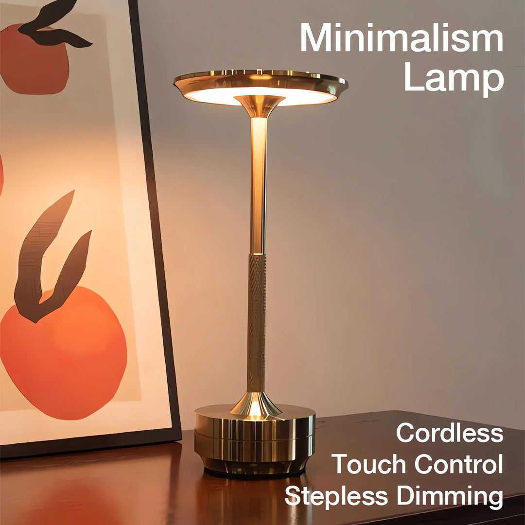 Modern cordless table lamp with touch control, Nordic design, gold frame, brushed finish, illuminating a stylish room.