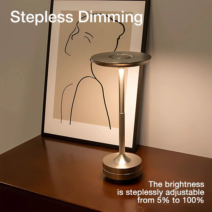 Modern cordless table lamp with touch control, Nordic design, gold frame, brushed finish, illuminating a stylish room.