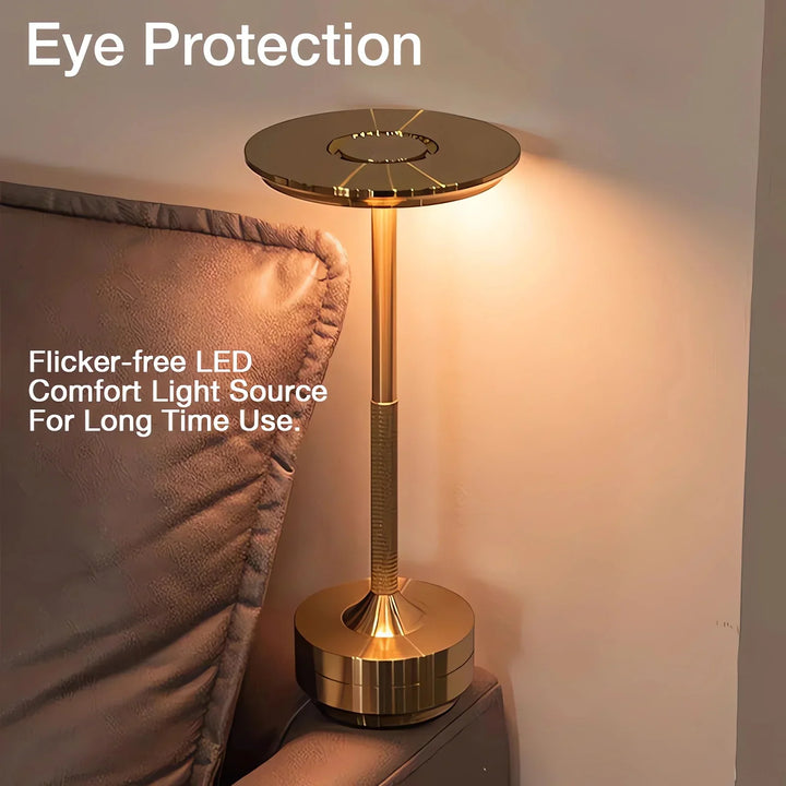 Modern cordless table lamp with touch control, Nordic design, gold frame, brushed finish, illuminating a stylish room.