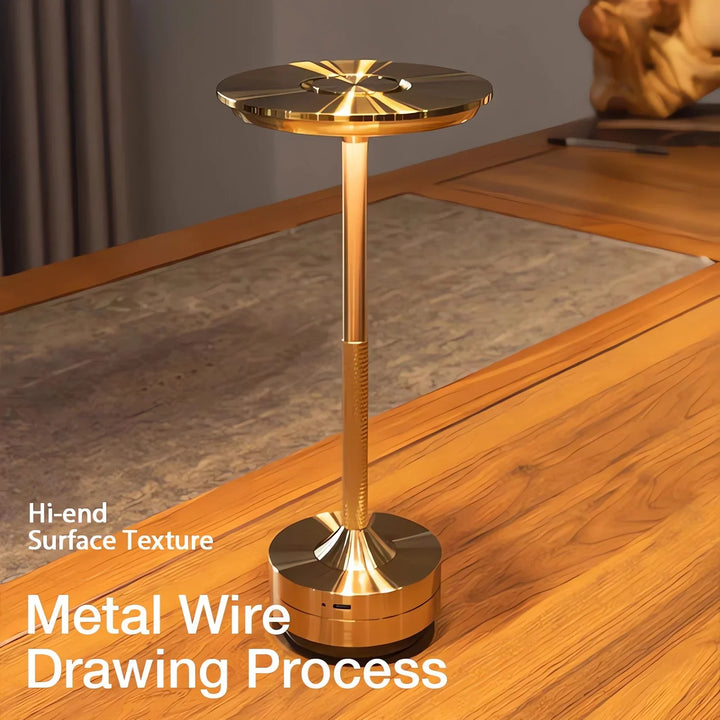 Modern cordless table lamp with touch control, Nordic design, gold frame, brushed finish, illuminating a stylish room.