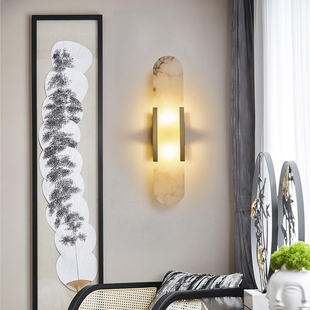 "Modern elongated alabaster wall lamp with metal and brass accents, emits warm glow, suitable for chic interior decor."