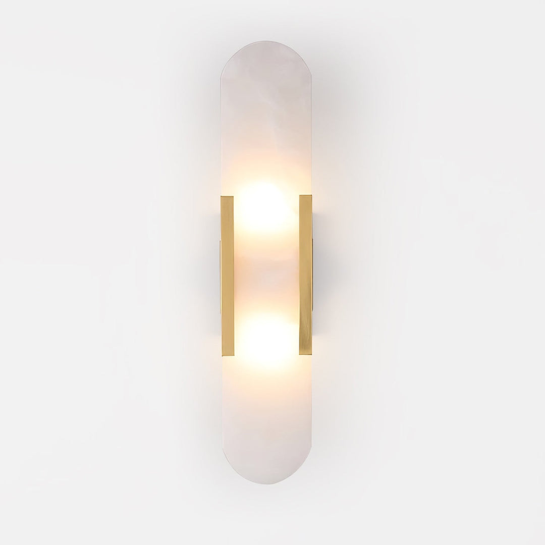 "Modern elongated alabaster wall lamp with metal and brass accents, emits warm glow, suitable for chic interior decor."