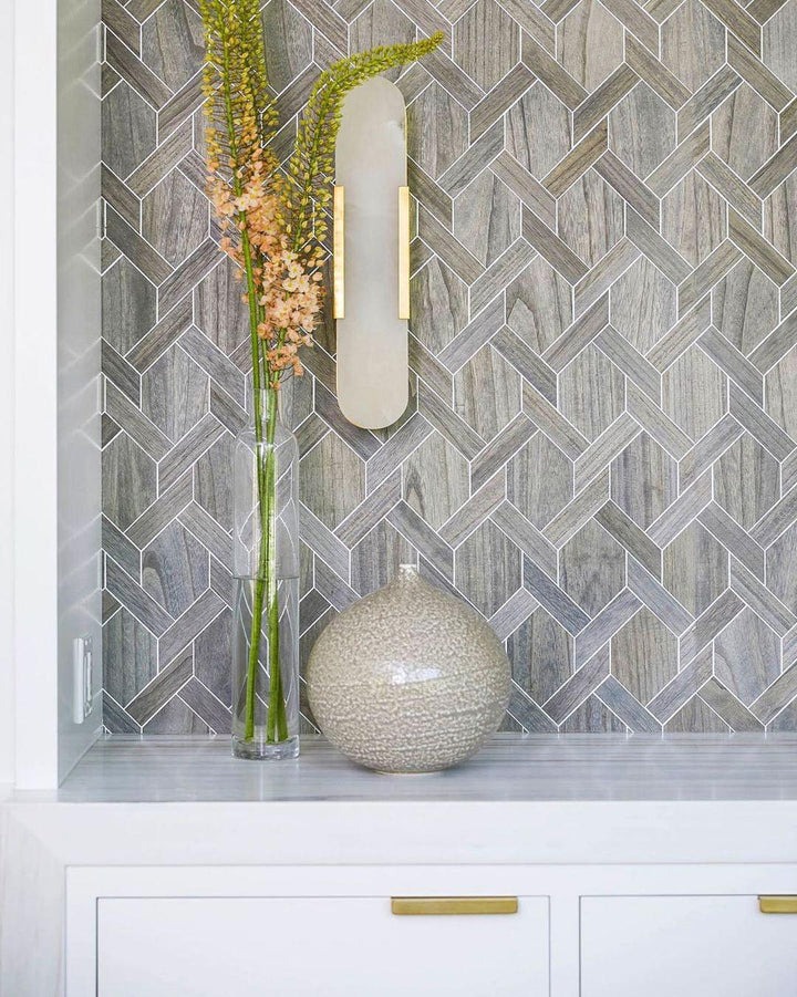 "Modern elongated alabaster wall lamp with metal and brass accents, emits warm glow, suitable for chic interior decor."