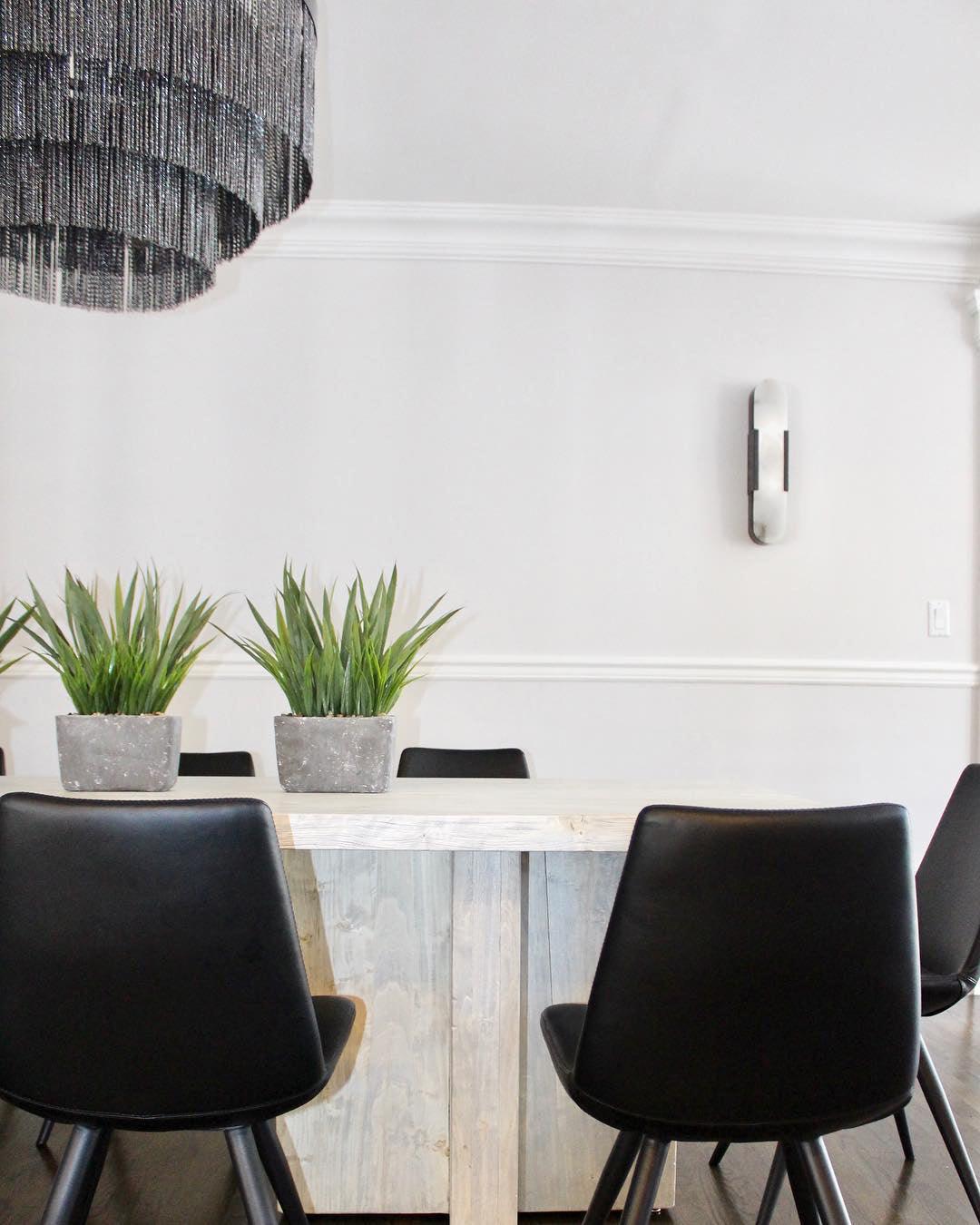 "Modern elongated alabaster wall lamp with metal and brass accents, emits warm glow, suitable for chic interior decor."