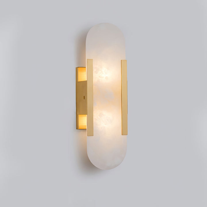 "Modern elongated alabaster wall lamp with metal and brass accents, emits warm glow, suitable for chic interior decor."