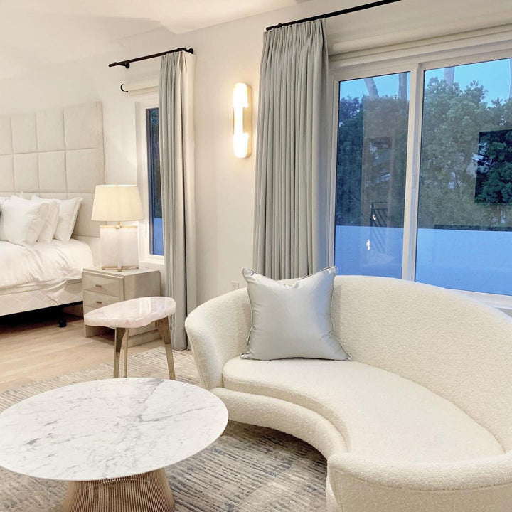 "Modern elongated alabaster wall lamp with metal and brass accents, emits warm glow, suitable for chic interior decor."