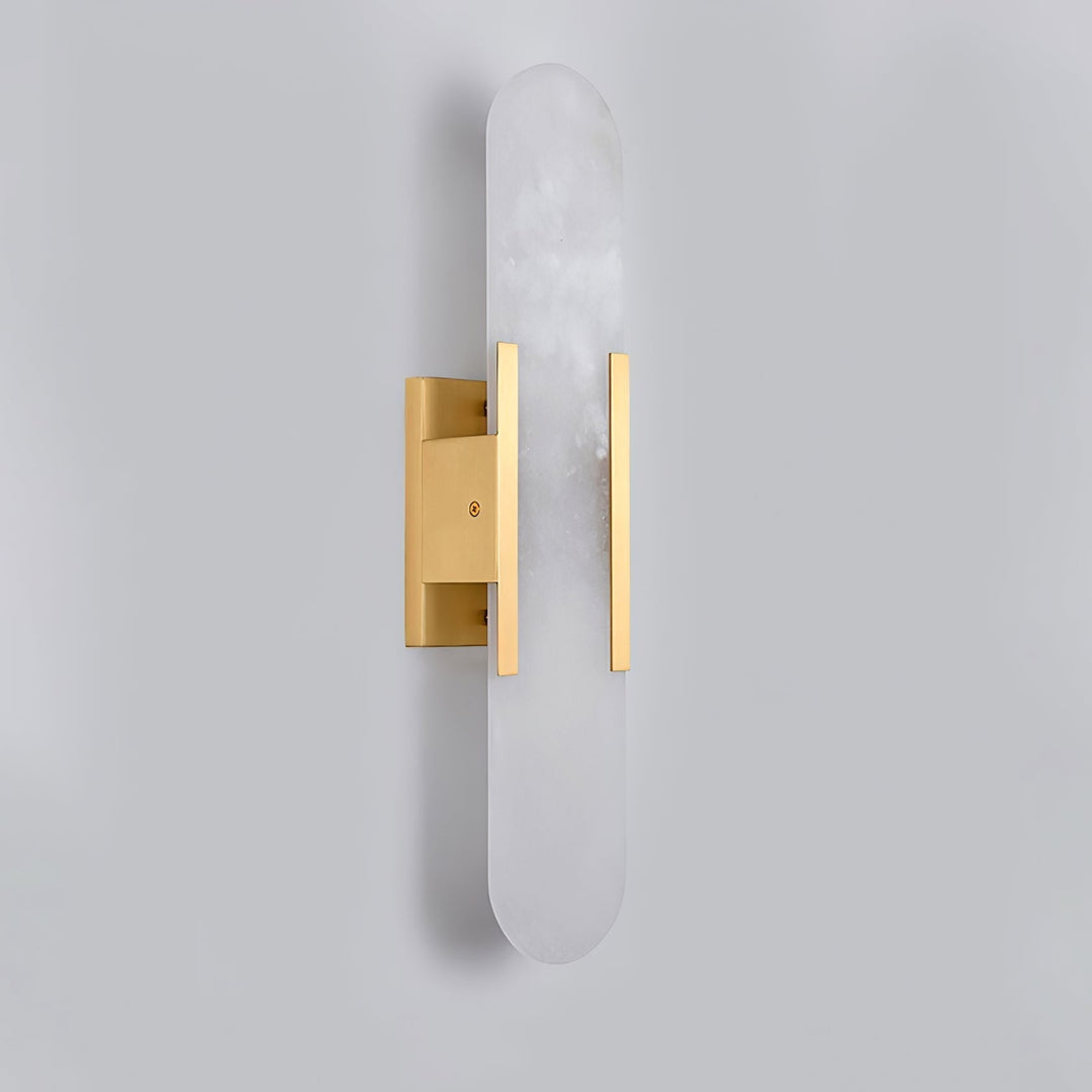 "Modern elongated alabaster wall lamp with metal and brass accents, emits warm glow, suitable for chic interior decor."