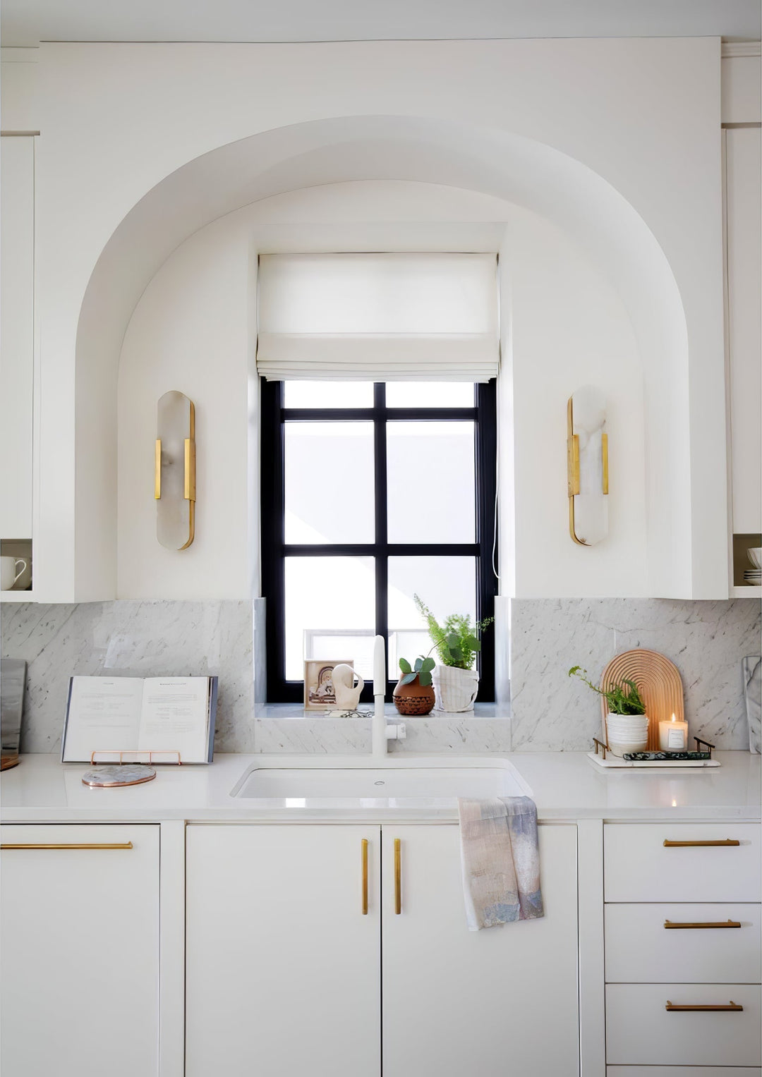 "Modern elongated alabaster wall lamp with metal and brass accents, emits warm glow, suitable for chic interior decor."