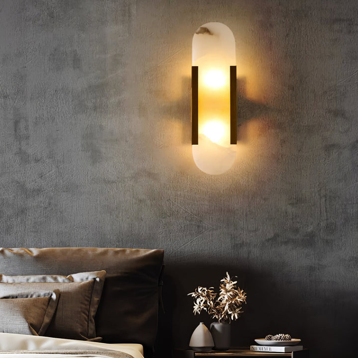 "Modern elongated alabaster wall lamp with metal and brass accents, emits warm glow, suitable for chic interior decor."