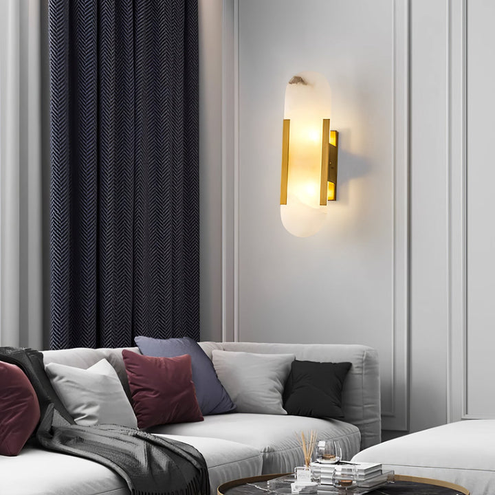 "Modern elongated alabaster wall lamp with metal and brass accents, emits warm glow, suitable for chic interior decor."