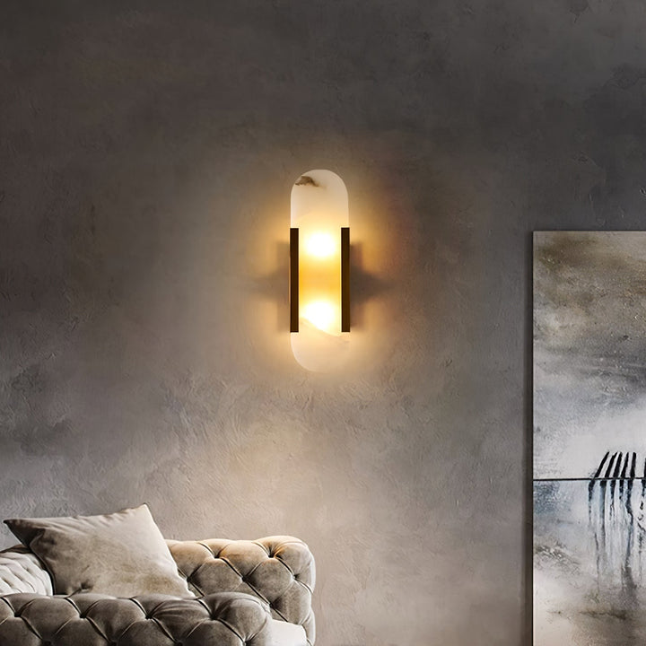 "Modern elongated alabaster wall lamp with metal and brass accents, emits warm glow, suitable for chic interior decor."
