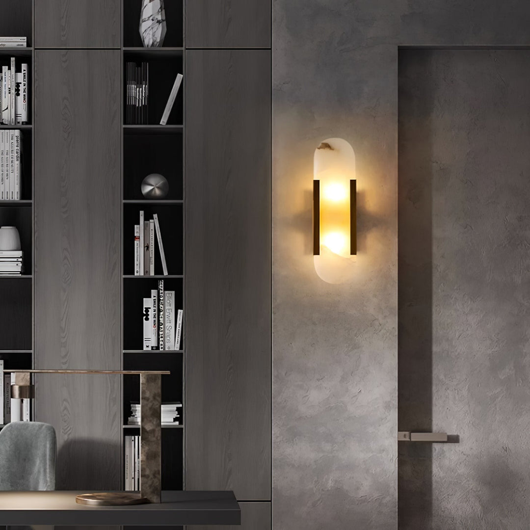 "Modern elongated alabaster wall lamp with metal and brass accents, emits warm glow, suitable for chic interior decor."