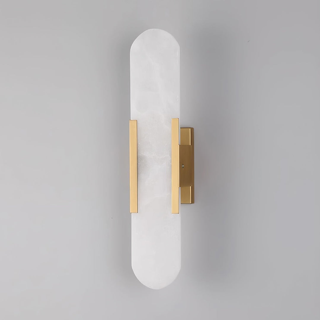 "Modern elongated alabaster wall lamp with metal and brass accents, emits warm glow, suitable for chic interior decor."