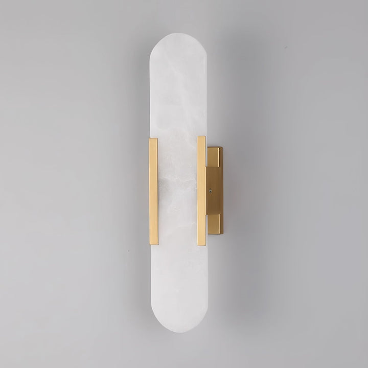 "Modern elongated alabaster wall lamp with metal and brass accents, emits warm glow, suitable for chic interior decor."