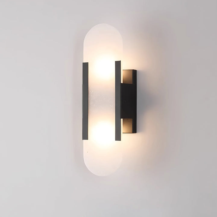"Modern elongated alabaster wall lamp with metal and brass accents, emits warm glow, suitable for chic interior decor."