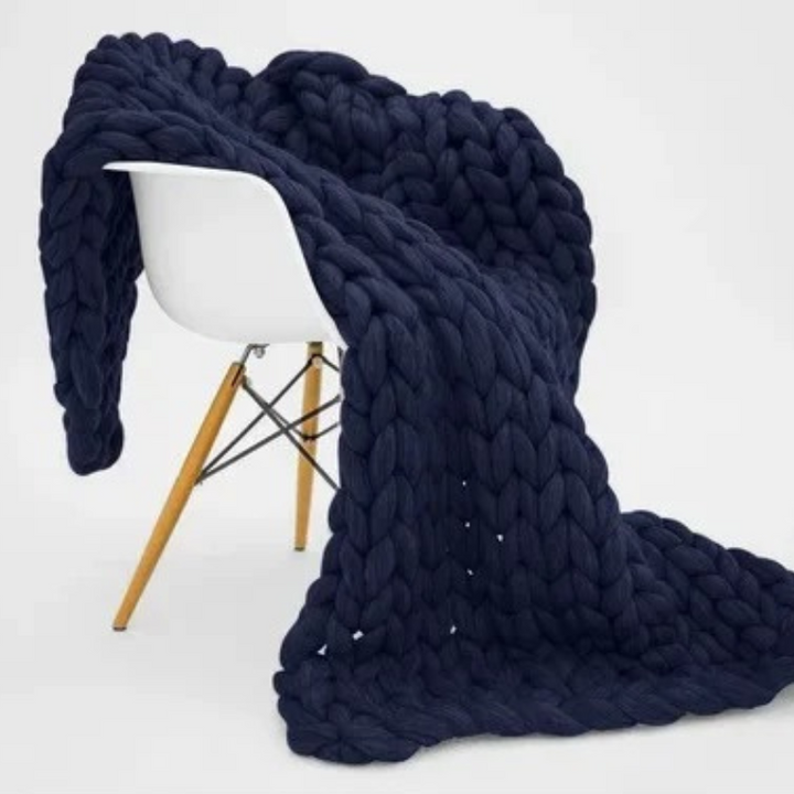 "Organic cotton weighted blanket in grey, offering cozy warmth and therapeutic pressure for all seasons. Available in multipl