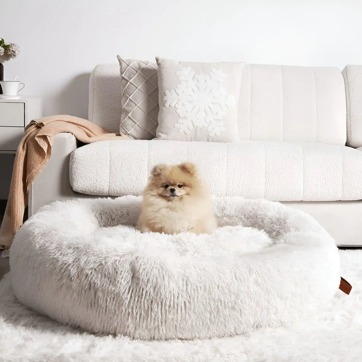 "Plush luxury dog bed for anxiety relief in apricot color, round with raised rim, available in multiple sizes."