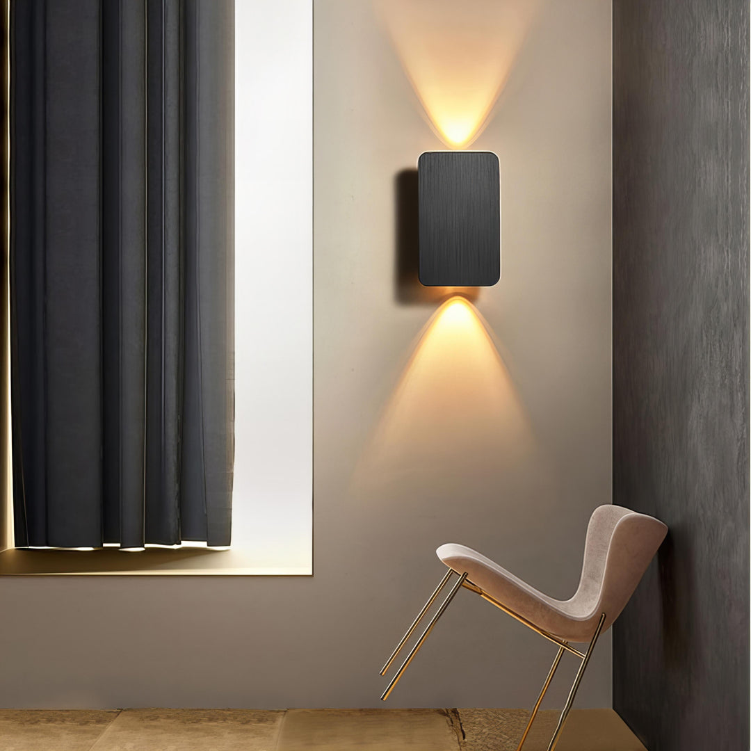 "Sleek indoor LED wall lamp with a modern rectangular design, featuring smooth finishes and warm illumination for elegant dec