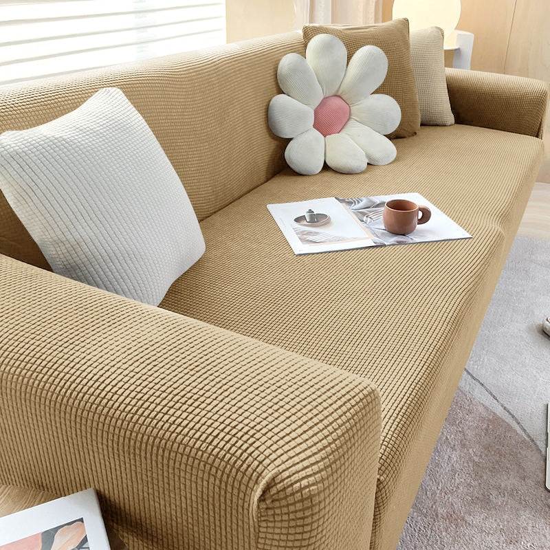 "Textured stretch sofa cover in beige, snug fit for sofas, non-slip, adds elegance, protects against spills and wear."