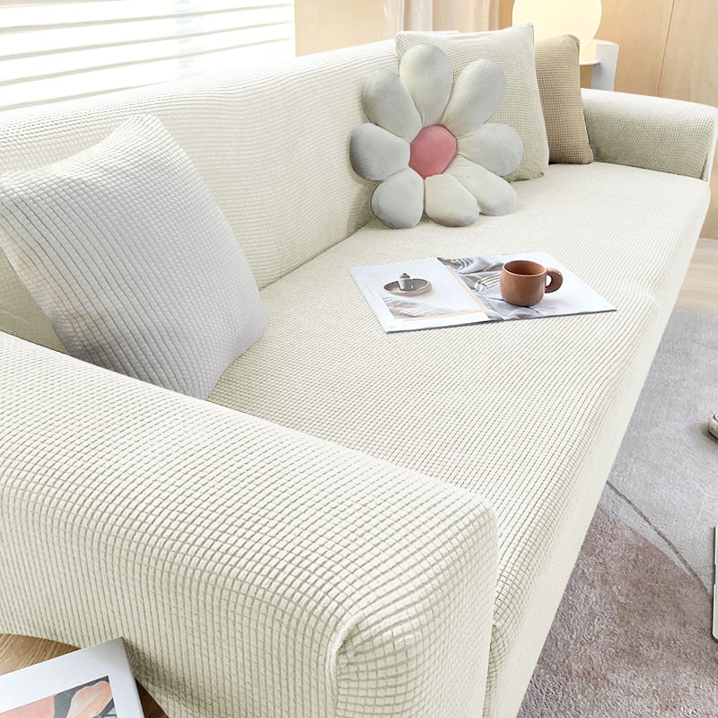 "Textured stretch sofa cover in beige, snug fit for sofas, non-slip, adds elegance, protects against spills and wear."