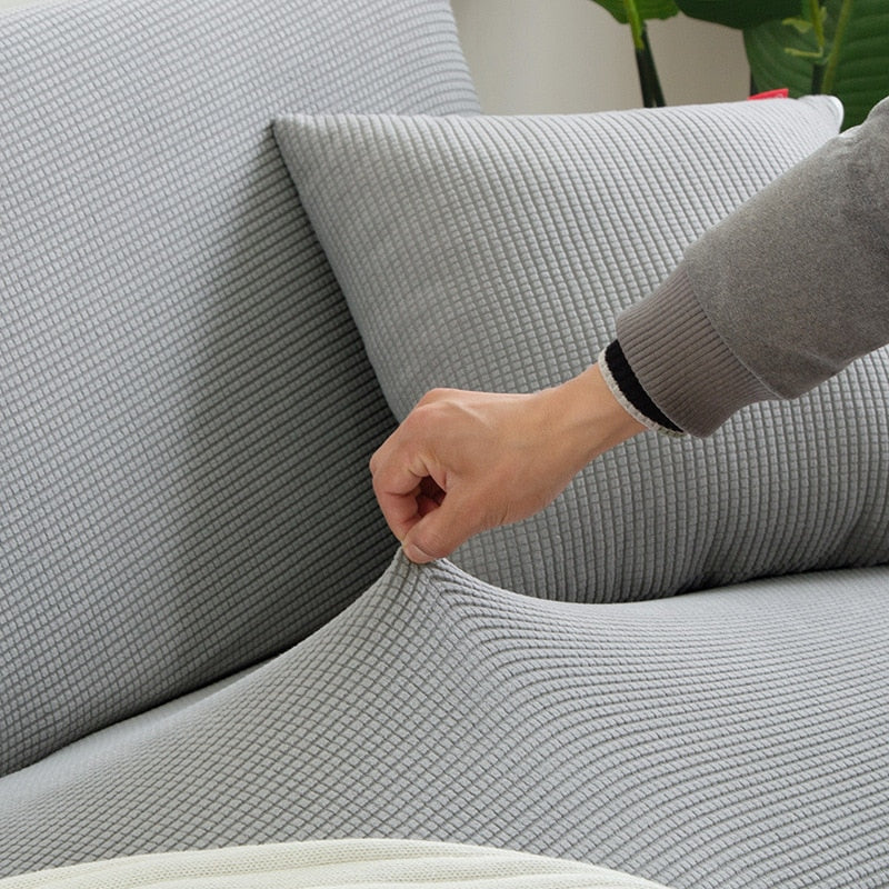 "Textured stretch sofa cover in beige, snug fit for sofas, non-slip, adds elegance, protects against spills and wear."