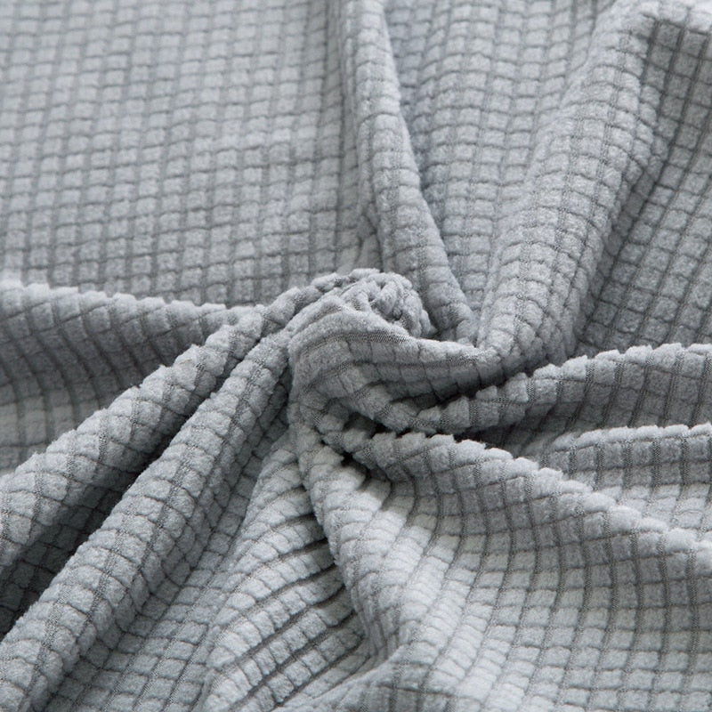 "Textured stretch sofa cover in beige, snug fit for sofas, non-slip, adds elegance, protects against spills and wear."