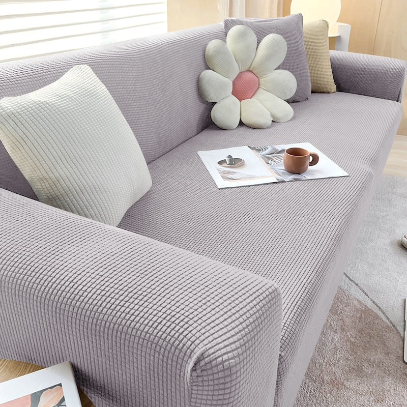 "Textured stretch sofa cover in beige, snug fit for sofas, non-slip, adds elegance, protects against spills and wear."