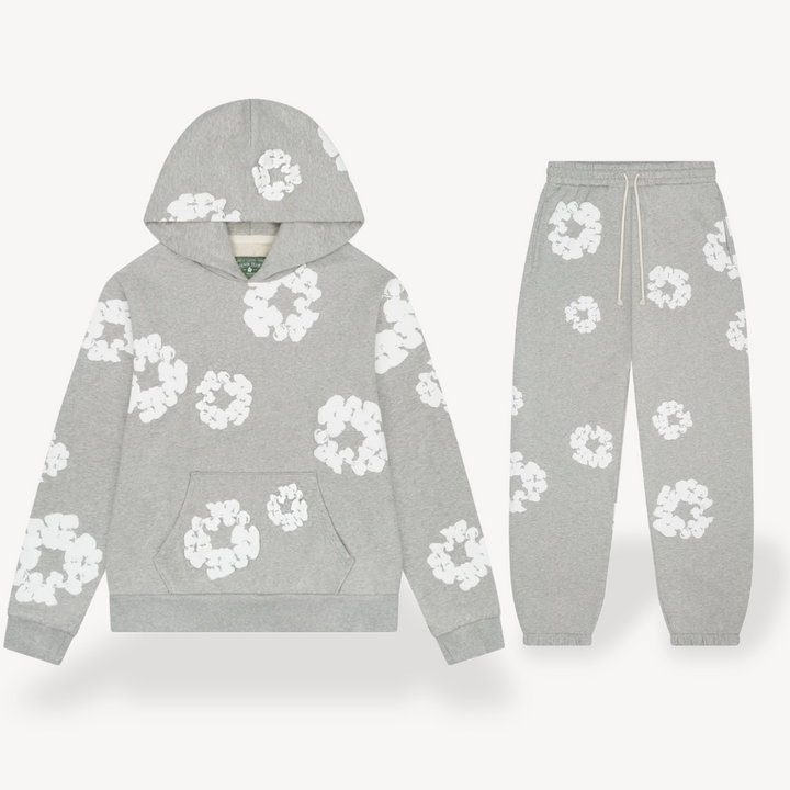 Unisex hoodie with bold white floral graphics on black cotton, combines style and comfort for a standout look.