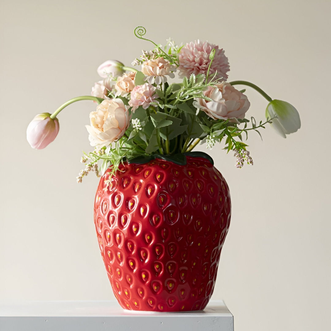 "Vibrant strawberry ceramic vase with whimsical design, perfect for home decor and flower displays, adds playful charm."