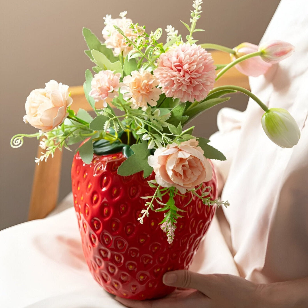 "Vibrant strawberry ceramic vase with whimsical design, perfect for home decor and flower displays, adds playful charm."