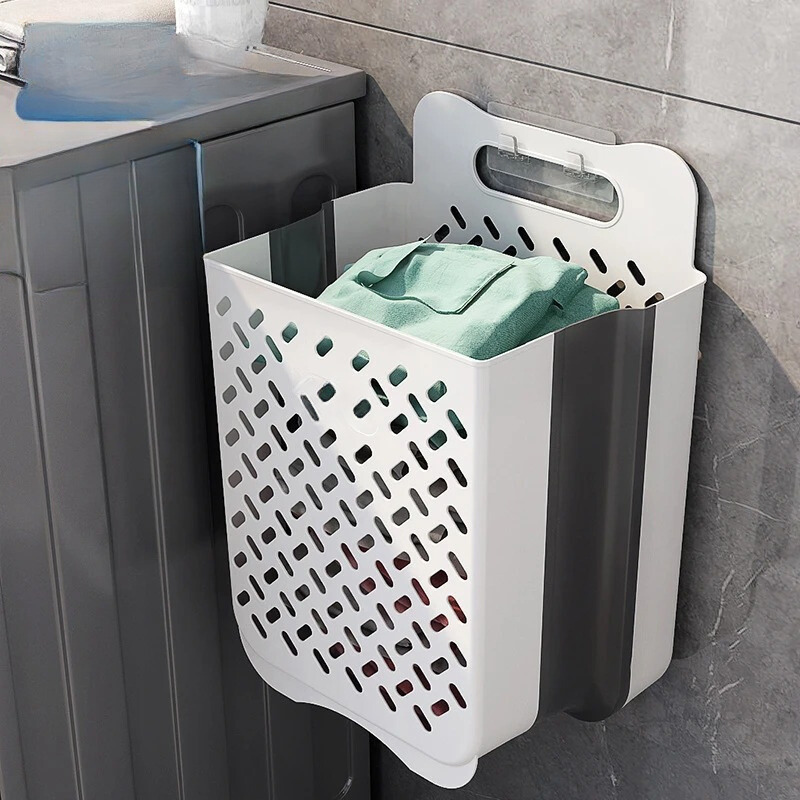 "Wall-mounted foldable laundry basket with breathable mesh design, shown unfolded and mounted on a wall for space-saving use.