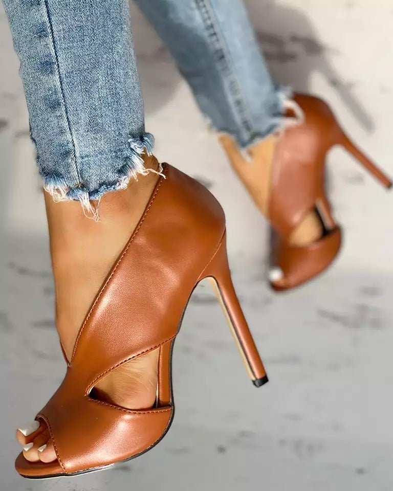 "Women's black & brown open-toe stiletto heels with side cutouts, peep-toe design, sleek silhouette, and slip-on style."