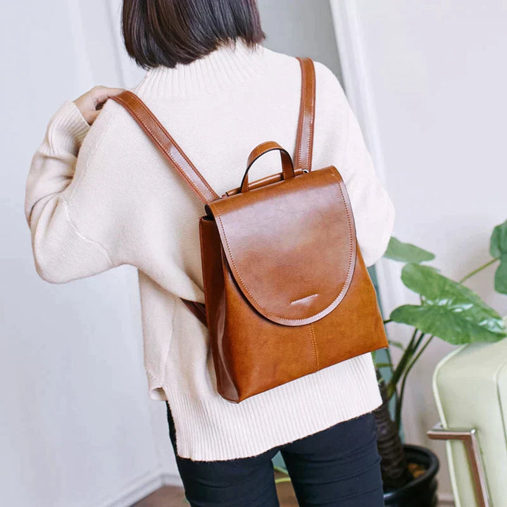"Women's chic leather backpack, minimalist design, high-quality leather, adjustable straps, versatile for work and travel."
