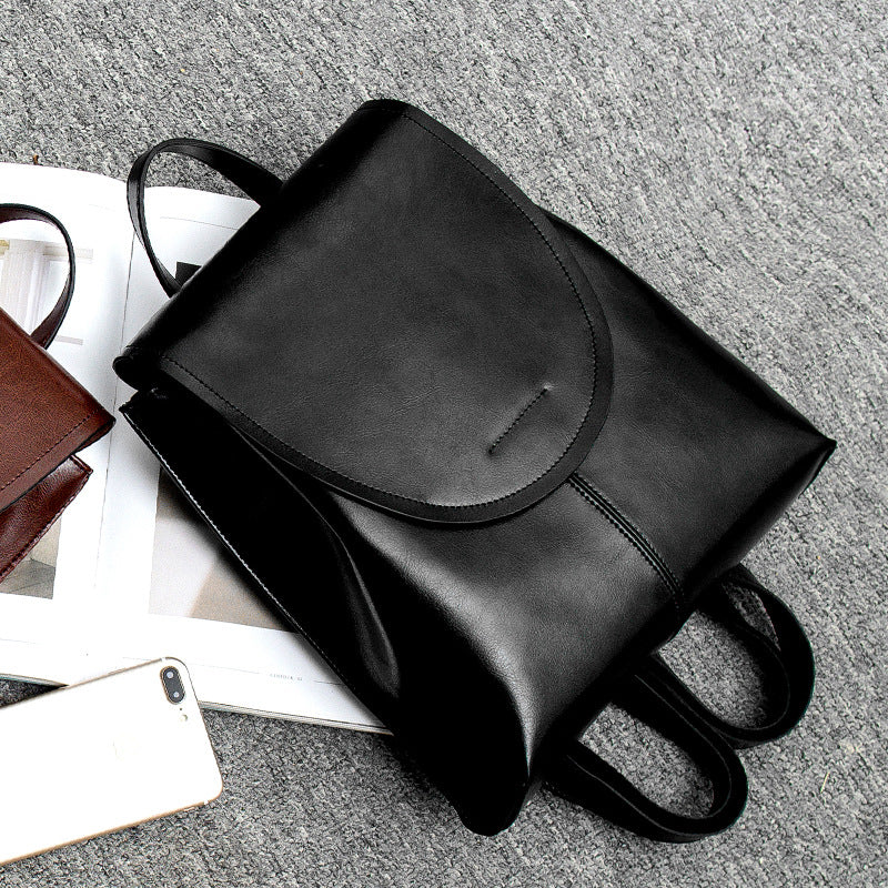 "Women's chic leather backpack, minimalist design, high-quality leather, adjustable straps, versatile for work and travel."