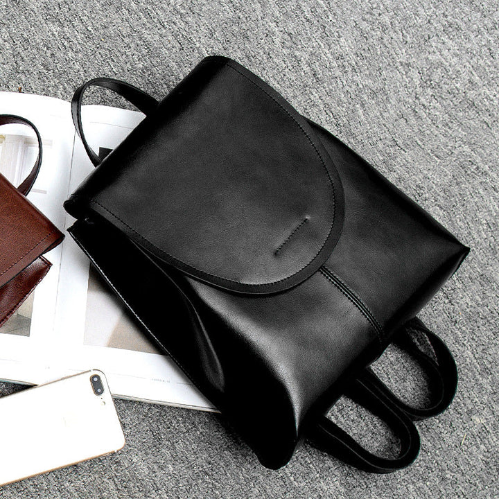 "Women's chic leather backpack, minimalist design, high-quality leather, adjustable straps, versatile for work and travel."