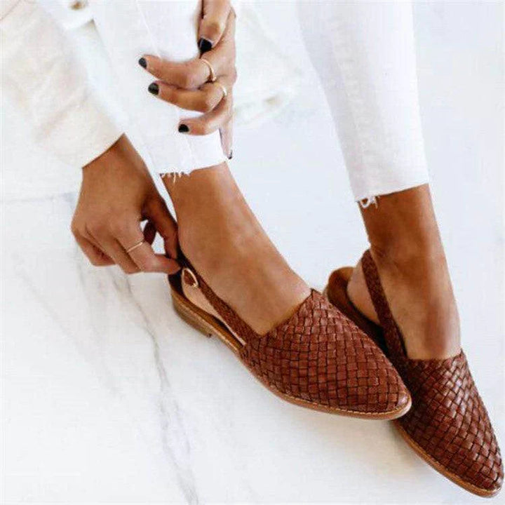 "Women's comfortable woven leather slingback flats, closed toe, with secure strap and elegant design for versatile wear."