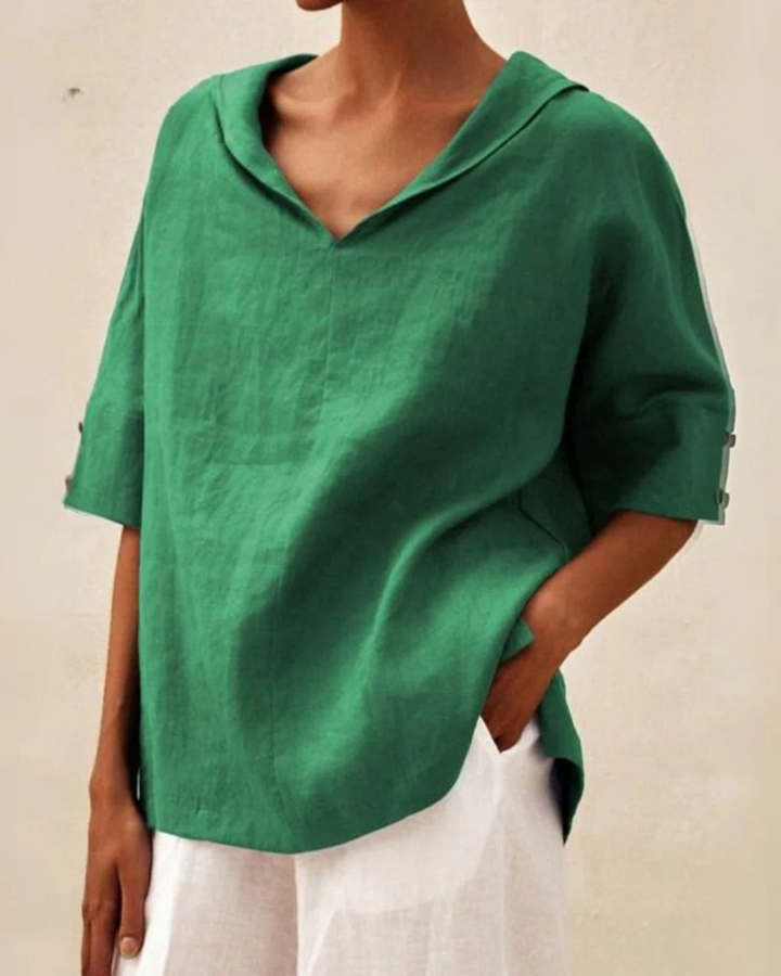 "Women's linen blouse with V-neck and half sleeves, lightweight fabric, chic design, ideal for spring and summer wear."