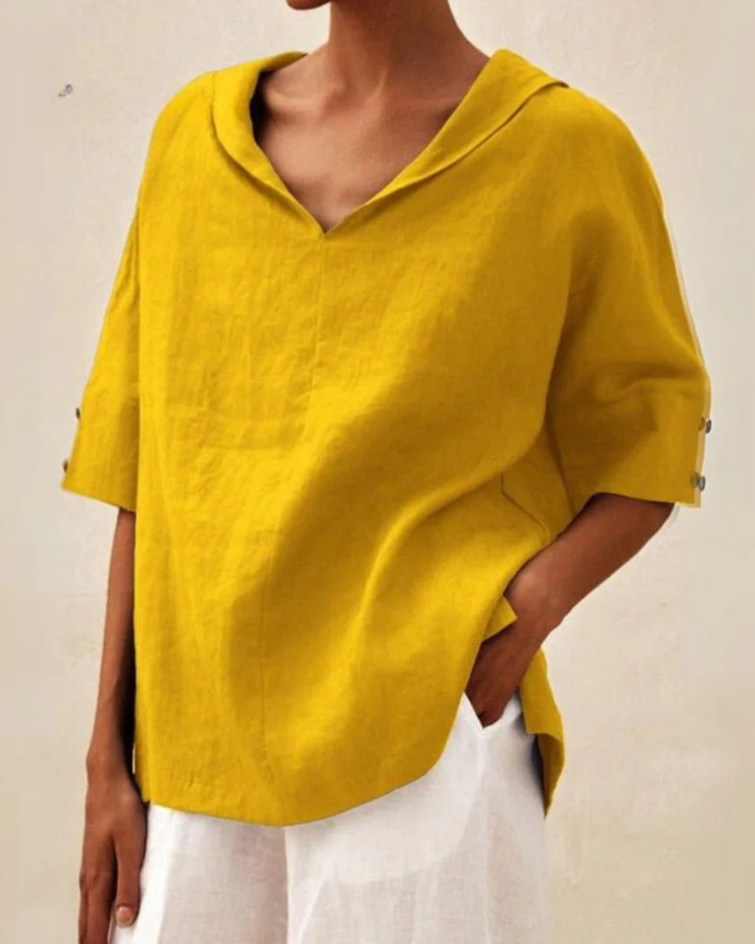 "Women's linen blouse with V-neck and half sleeves, lightweight fabric, chic design, ideal for spring and summer wear."