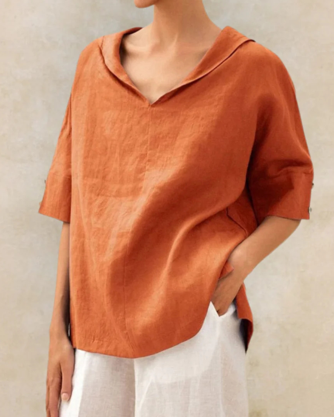 "Women's linen blouse with V-neck and half sleeves, lightweight fabric, chic design, ideal for spring and summer wear."