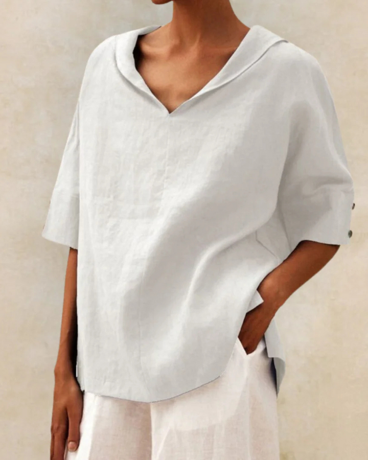 "Women's linen blouse with V-neck and half sleeves, lightweight fabric, chic design, ideal for spring and summer wear."