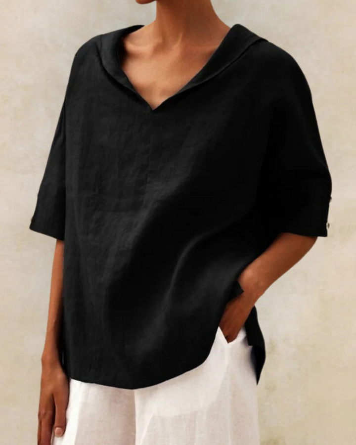 "Women's linen blouse with V-neck and half sleeves, lightweight fabric, chic design, ideal for spring and summer wear."