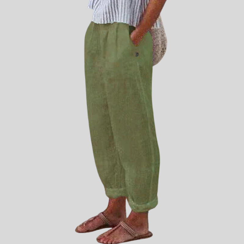 "Women's linen trousers with folded hem, relaxed fit; lightweight, breathable fabric, beige tones, tailored style."