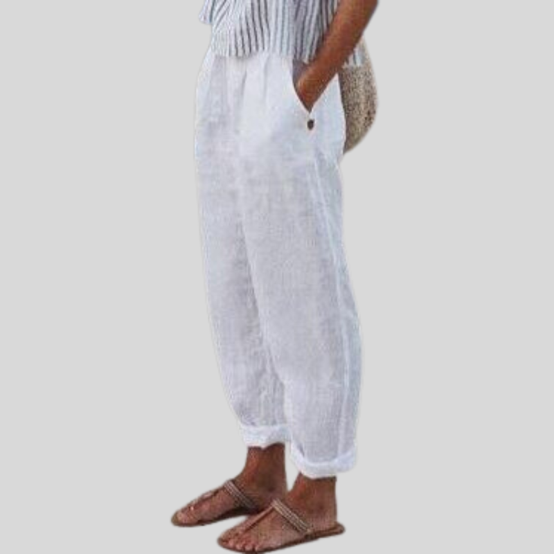 "Women's linen trousers with folded hem, relaxed fit; lightweight, breathable fabric, beige tones, tailored style."
