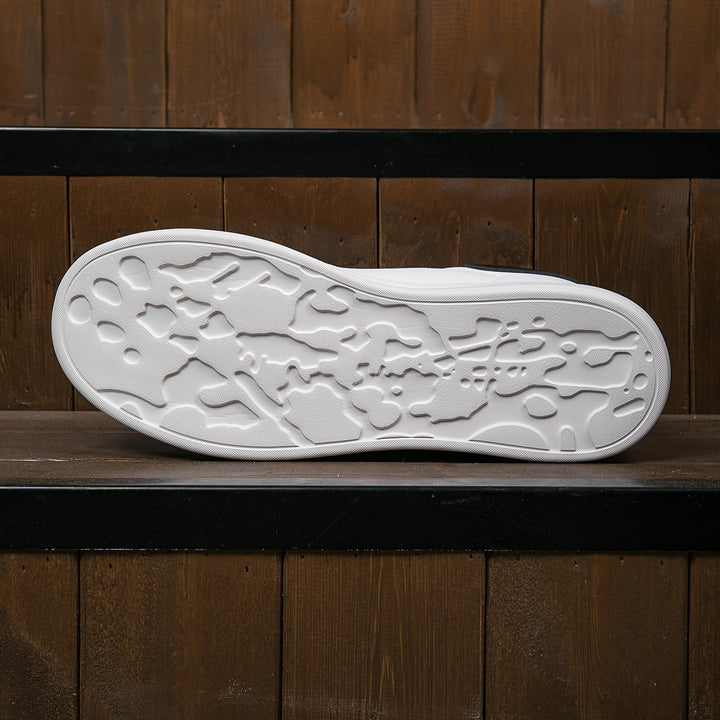 "Women's minimalist white leather sneakers with sleek design and cushioned soles, ideal for casual wear and comfort."