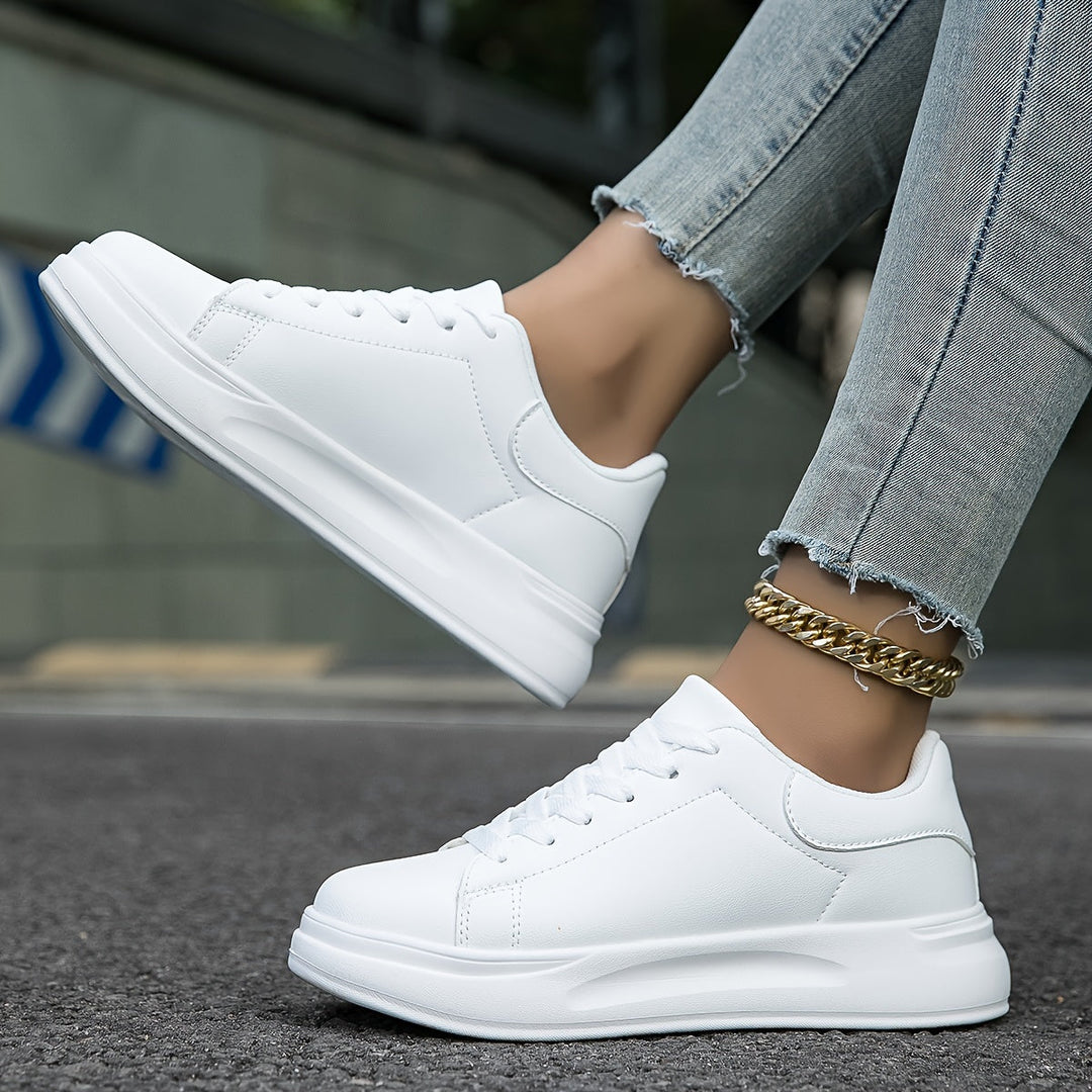 "Women's minimalist white leather sneakers with sleek design and cushioned soles, ideal for casual wear and comfort."