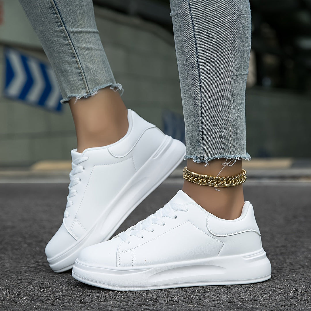 "Women's minimalist white leather sneakers with sleek design and cushioned soles, ideal for casual wear and comfort."