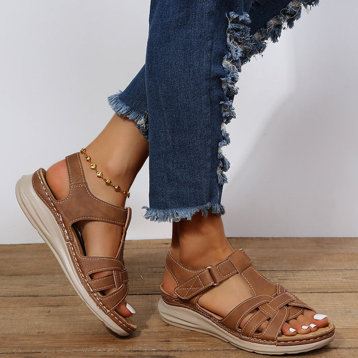 "Women's orthopedic sandals with Velcro straps, faux leather, cushioned footbed, and rubber sole for comfort and style."